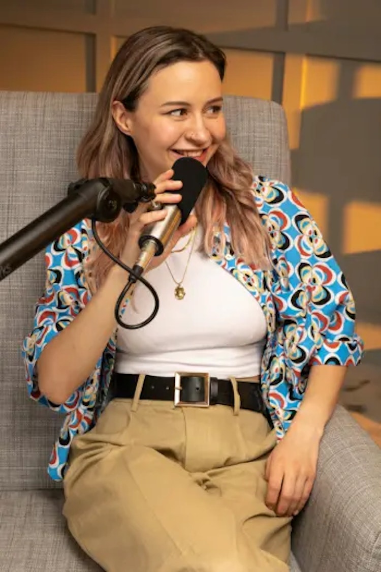 A podcast host with her podcasting microphone.