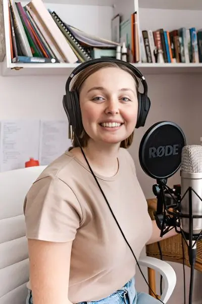 A podcast host with her podcasting microphone